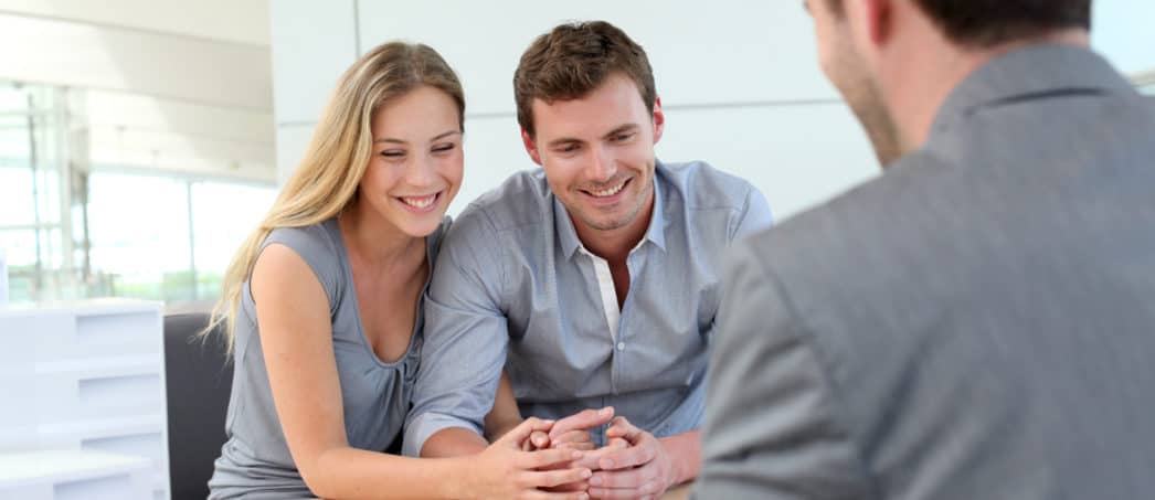 Newly married couple meeting with mortgage loan officer to learn about mortgages